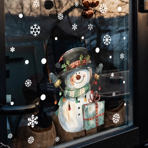 Detailed view of watercolor snowman window decals on glass with snowflakes and gift box