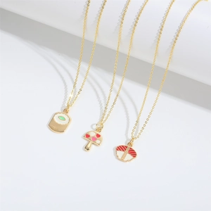 Cute mushroom and sushi pendant necklaces set on gold chains with vibrant enamel details