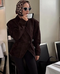 Detail of a brown suede V-neck blazer with matching leopard scarf and white sunglasses
