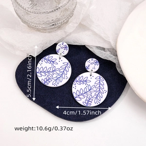 Detailed view of blue and white floral acrylic earrings with size and weight metrics