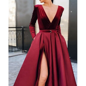 Elegant burgundy velvet V-neck evening gown with a high-slit satin skirt and waist belt