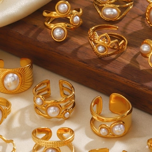 French style gold titanium steel pearl rings set on elegant satin and wood display