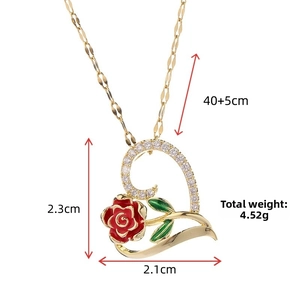 Detail shot of heart pendant with red rose and green leaf, measuring 2.3cm by 2.1cm
