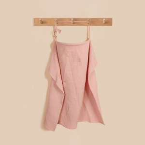 Detail of pink cotton waffle nursing cover with wooden adjustment ring on wood hanger