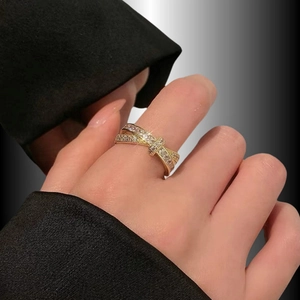 Elegant gold bow ring with micro-set zircons and twisted band on model's finger