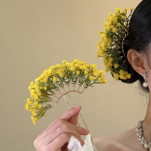 Elegant gold metal hair pin featuring delicate yellow flower petals and exquisite craftsmanship