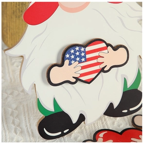 Close-up of wooden gnome ornament holding a heart with USA flag pattern