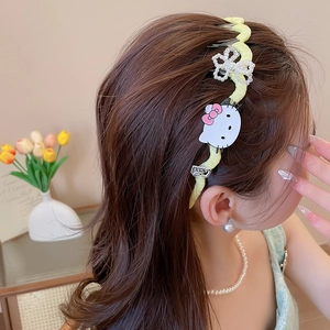 Detailed side view of a yellow wavy fabric headband with cartoon kitty and bead accents
