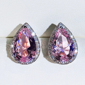 Close-up of pear-cut pink zircon earrings with halo setting in white jewelry box