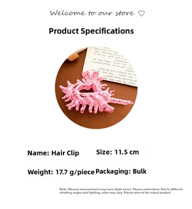 Macro view showing 11.5cm pink conch hair clip dimensions and red ink splatter texture