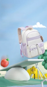 Lightweight purple and beige school backpack balancing on a seesaw against a blue sky