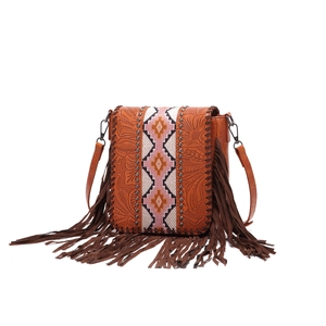 Detail of bohemian fringe shoulder bag with embossed leather and ethnic woven patterns
