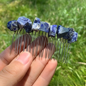 Detailed macro of handmade raw blue crystal stones wired on a silver hair comb