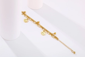 Close-up of gold double-layer star moon bracelet with paperclip and cuban links