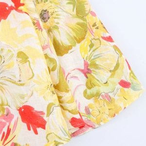 Close-up of linen-blend fabric featuring colorful floral prints and natural texture