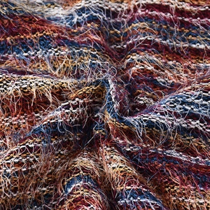 Detailed macro view of the colorful multi-colored woven knit fabric texture and soft fibers