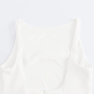 Detail of white sleeveless dress showing deep round backless design and hidden zipper