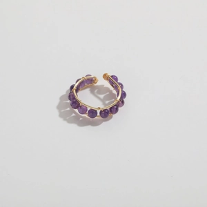 Detail of handmade 14K gold-plated wire-wrapped ring featuring natural purple amethyst beads