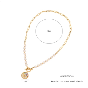 Detail of a 46cm stainless steel gold chain with pearls and a smiley pendant