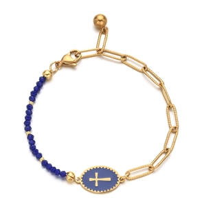 Detail of cross charm bracelet with gold links and deep blue faceted beads