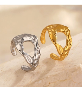 Detail view of irregular hammered lava texture rings in 18K gold and silver finishes