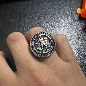 Detail of vintage steel ring with red Templar cross shield and biblical engraving
