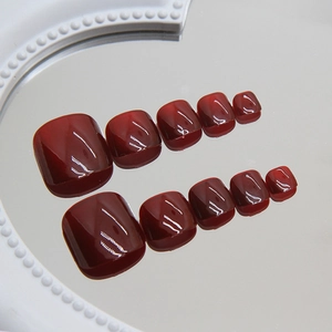 Dunkelrote Katzenaugen-Zehennägel zum Aufkleben mit Hochglanz-Finish und tiefem Weinrot