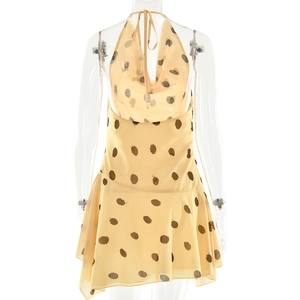 Detail view of the open back design on a yellow polka dot halter neck summer dress