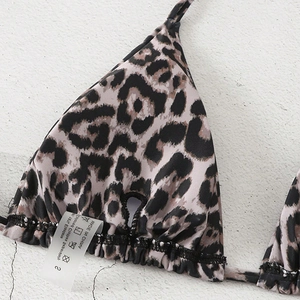 Detail shot of leopard print bikini top showing fabric texture and wash care label