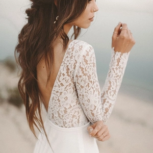 Elegant white lace A-line wedding dress with long sleeves and open back design
