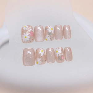 Cat eye press-on nails with daisy floral designs and gold flakes on short square tips