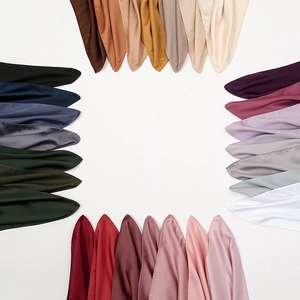 Folded large solid color satin square scarves in multiple vibrant colors arranged in a frame