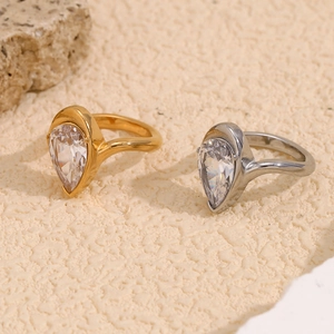 18K gold plated stainless steel rings featuring pear-cut white zircon stones on sand