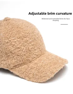 Detail of beige fleece baseball cap featuring wide curved brim and thick plush texture