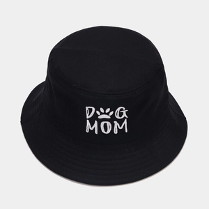 Close-up of white Dog Mom embroidery and paw print on a black cotton bucket hat