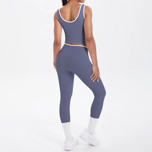 Rear view of two-piece gray-blue yoga set with white contrast trim and high waist leggings