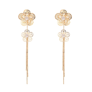 Elegant gold flower tassel earrings with hollow petals and zircon crystals on white background