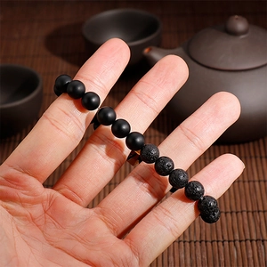 Lava stone and matte black bead bracelet featuring a stainless steel initial charm