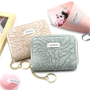 Floral embossed card holder wallets in beige and green with gold zipper and keychain