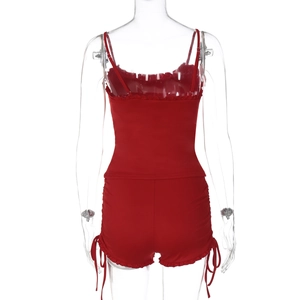 Detail view of red two-piece set featuring backless camisole and ruffled drawstring shorts