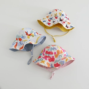 Detailed view of kids graffiti bucket hats with adjustable chin straps and cotton texture