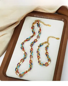 Macro detail of colorful enamel paperclip link jewelry set with gold-plated stainless steel