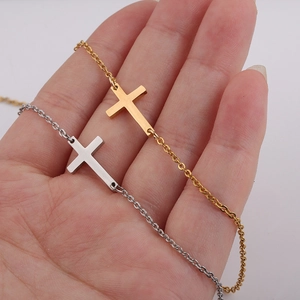 Detailed view of gold and silver stainless steel horizontal cross pendant bracelets