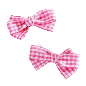 Pink and white checkered bow hair clips for women on a clean white background