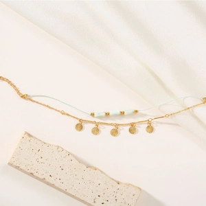 Double-layered titanium steel bracelet with sun pendant and green beads on blue cord