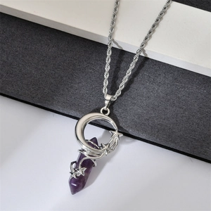 Macro shot of hexagonal purple crystal pendant featuring silver crescent moon and stars