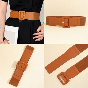 Detail view of brown elastic waist belt with rectangular pin buckle and faux leather finish