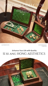 Detail of vintage walnut wood jewelry boxes with green velvet lining and glass lids