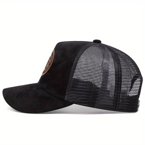 Side view of black trucker hat with mesh panels and brown round leather patch detail