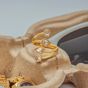 Detailed shot of a gold spiral ring with round and pear-shaped zircon stones